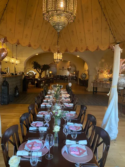 Long festive table under the tent roof at ArabesQ