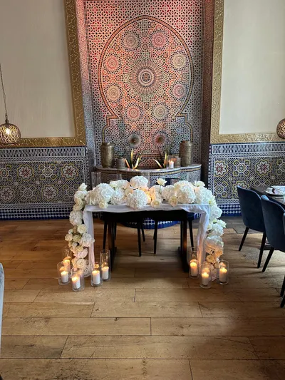 Lovingly decorated table in front of the mosaic fireplace at ArabesQ